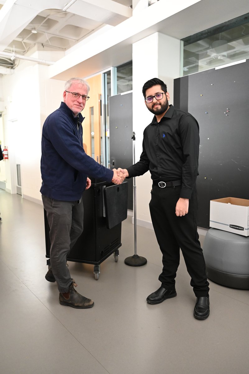 Muhammad receiving the award from Prof. Krieger