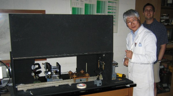 Photo of lab technologists working on BRI apparatus. 